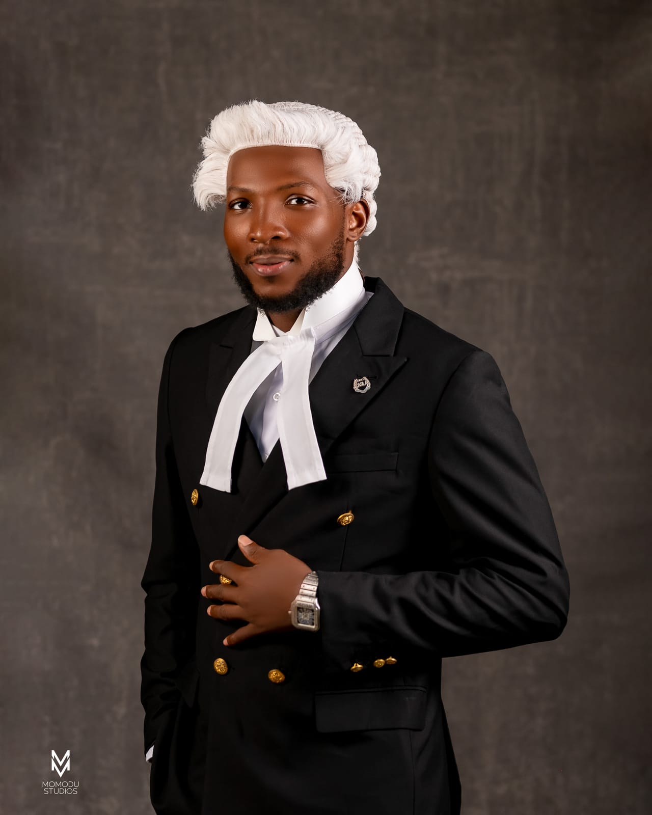 A new lawyer in wig and double-breasted suit, one hand on his chest